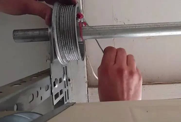 Residential garage door cable repair service in Garland TX fixing worn, loose, and broken garage door lifting cables.