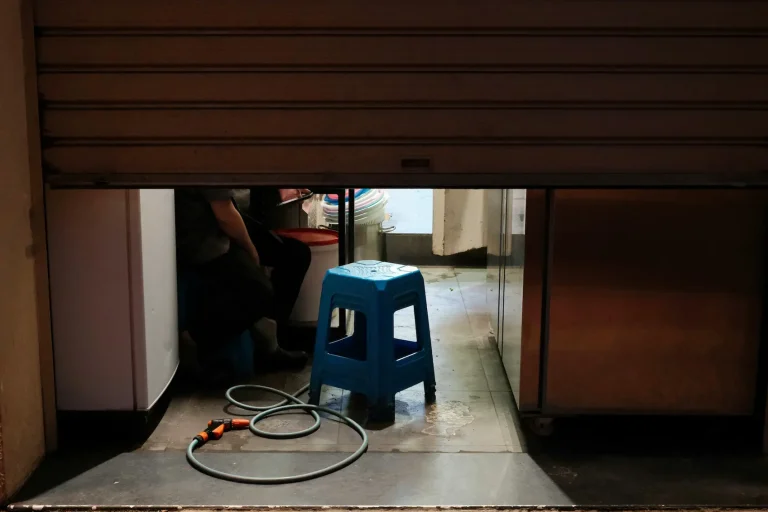 Commercial garage door repair technician servicing industrial overhead door system in Garland TX