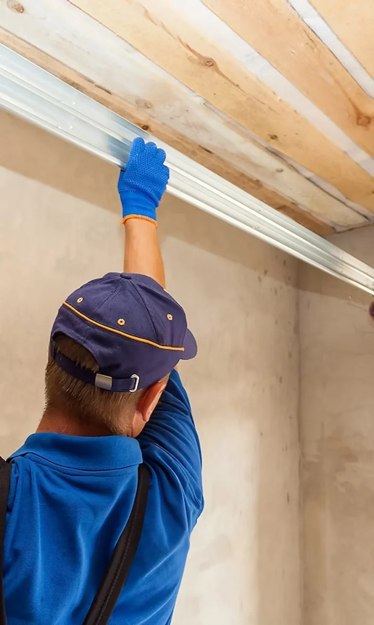 Emergency garage door repair technician fixing off-track garage door