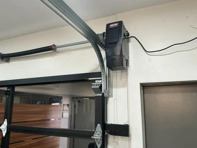 Garage door cable and roller repair technician replacing damaged components in Garland TX