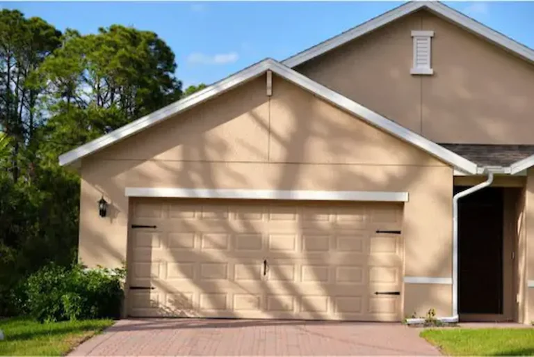 Garage door cable and roller replacement technician repairing damaged components
