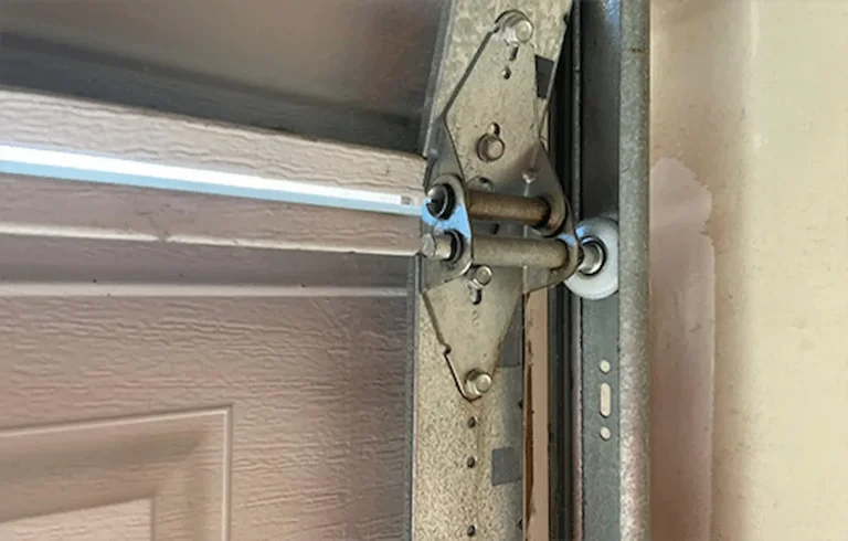 Professional garage door inspection, roller replacement, and track alignment process in Garland Texas.