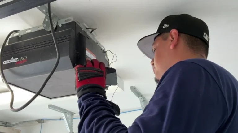 Emergency garage door repair technician fixing damaged off-track garage door in Garland TX